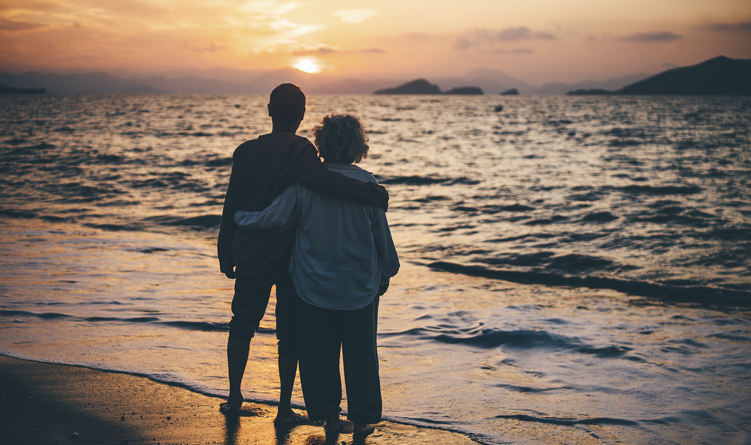 A couple watching the sunset on a beach
